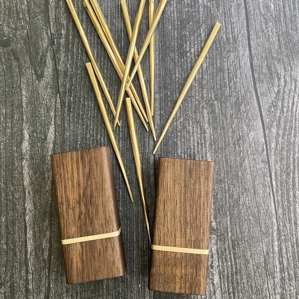 A beautifully crafted set of forged brass cocktail picks in an ebonized walnut and brass holder from The Dustworks