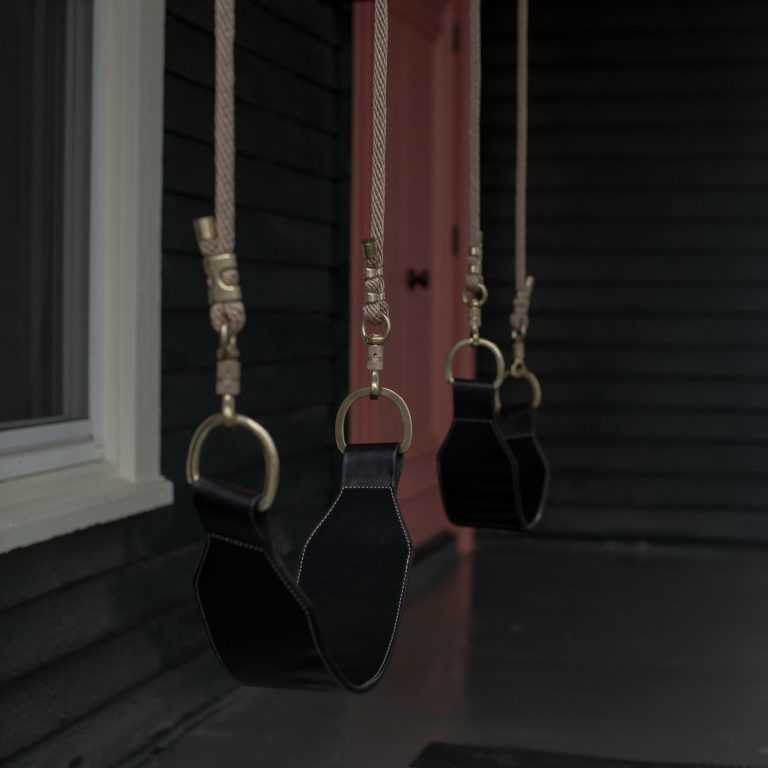 A black leather swing on a porch