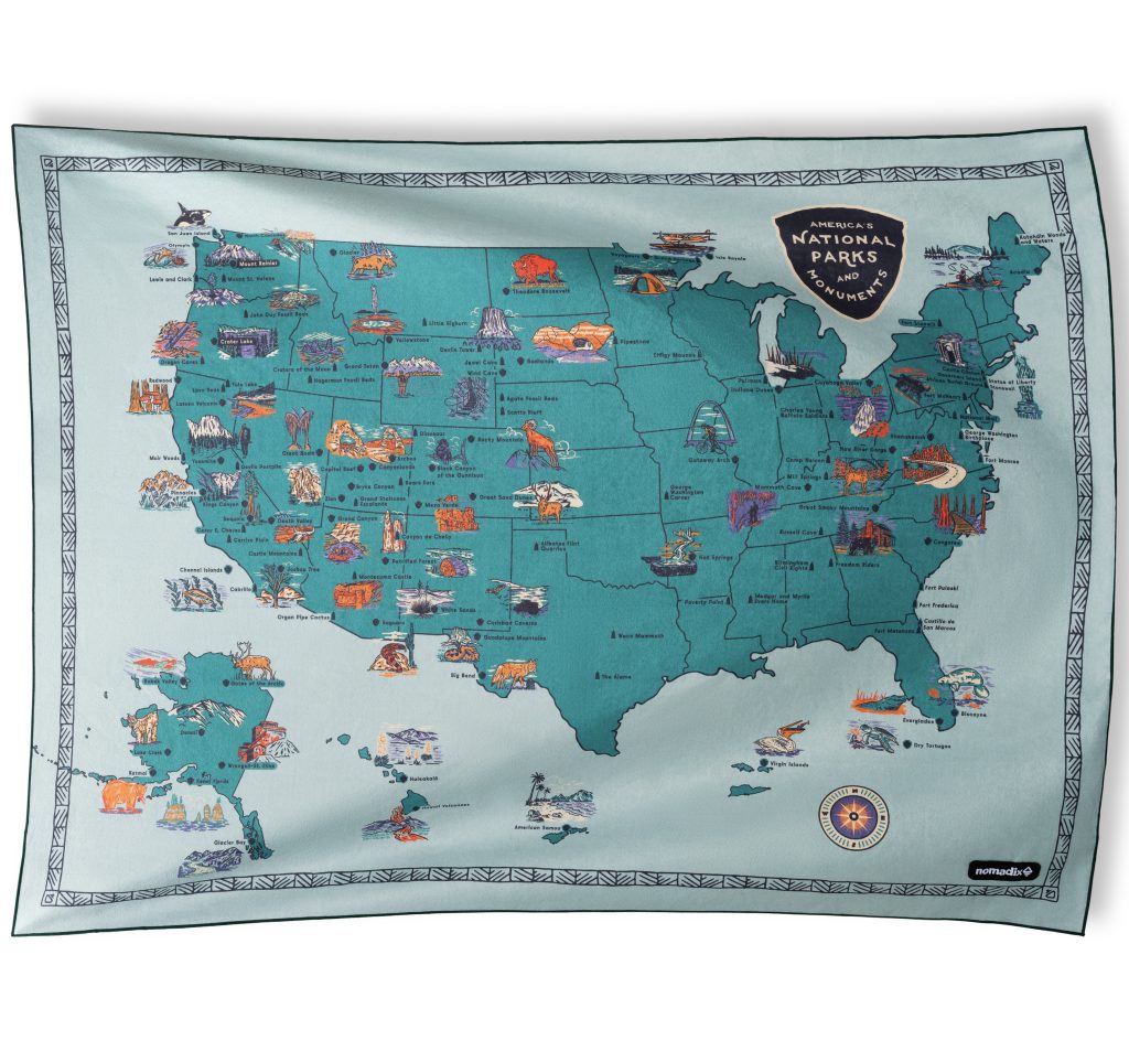 A colroful map of the US featuring its national parks on a large towel / blanket