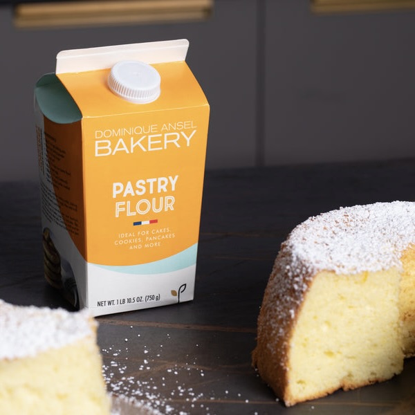 A box of Dominique Ansel 's new pastry flour in front of a cake